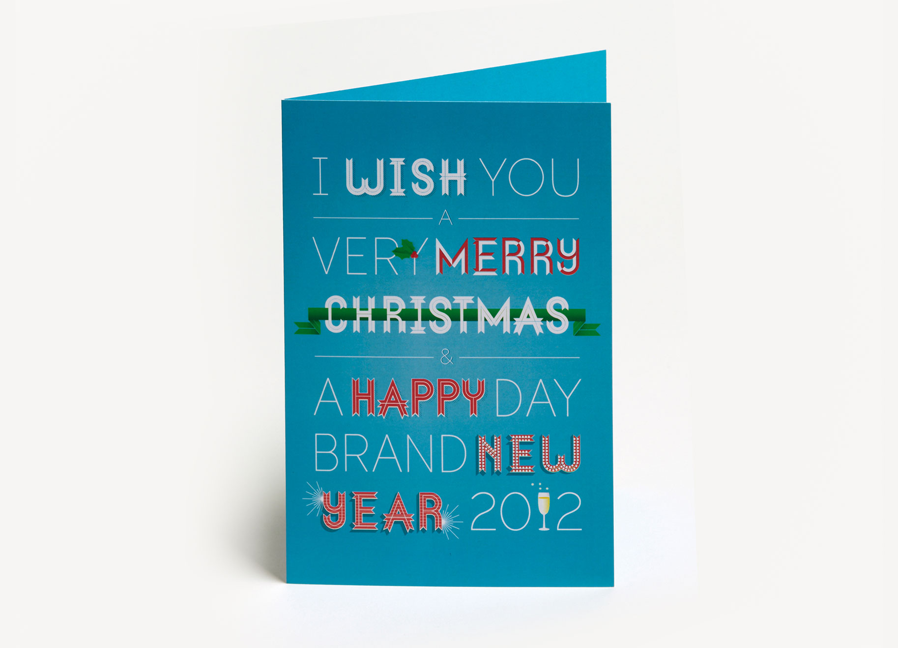 Typographic card with a turquoise background. Text reads : I wish you very Merry Christmas. A Happy Day. Brand New year 2012