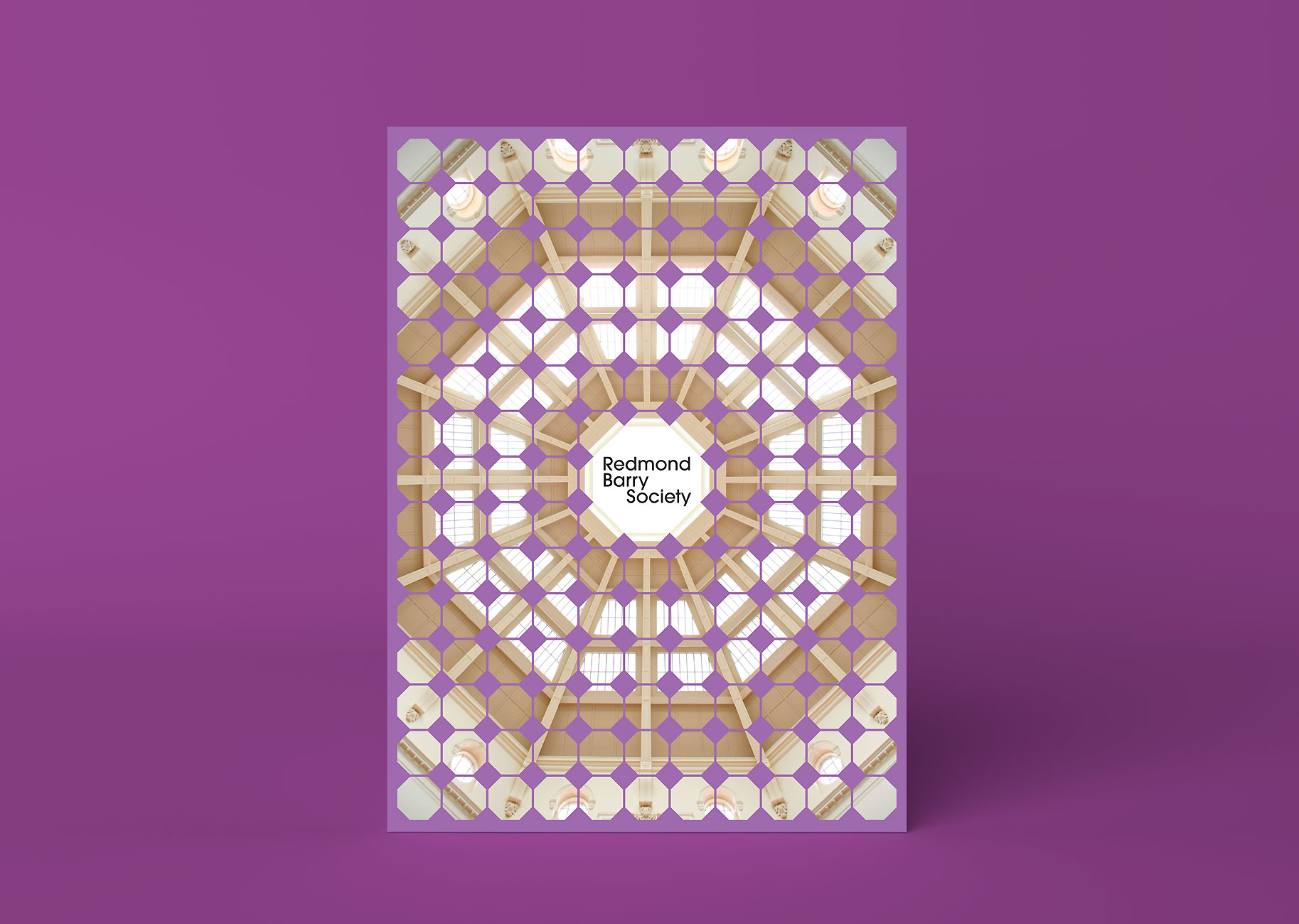 Redmond Barry Society invitation photographed from above on a purple background.