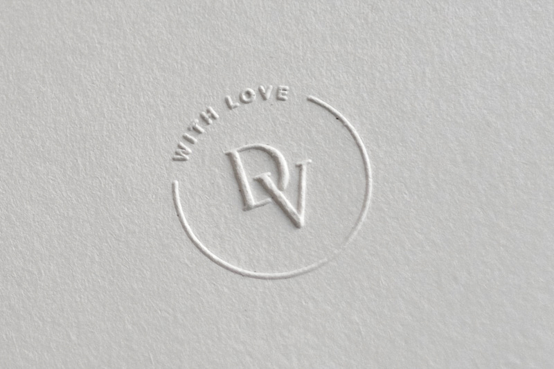 Close up view of embossed text and a monogram